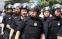 Xinjiang Police Patrol Tense City after Riots